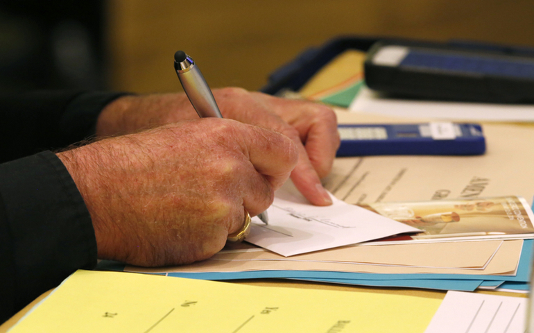 A bishop casts his vote during the 2015 fall general assembly of the U.S. Conference of Catholic Bishops in Baltimore. Bishops are scheduled to elect the next president and vice president at their upcoming assembly Nov. 14-16 in Baltimore. (CNS/Bob Roller)