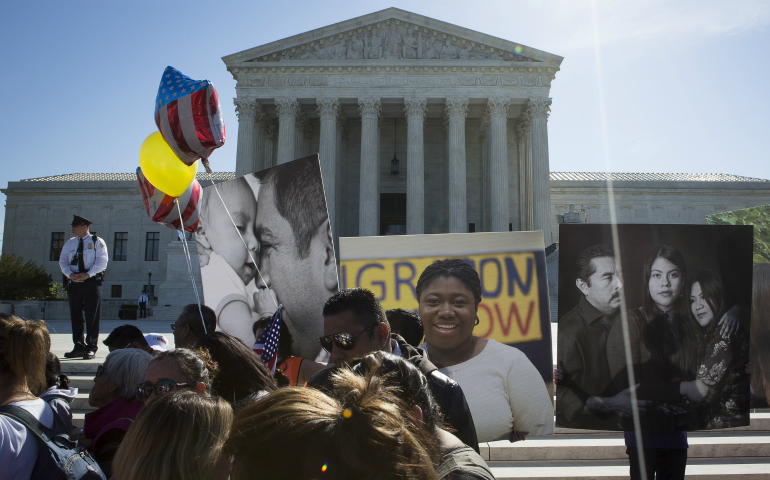 Supporters of the Deferred Action for Childhood Arrivals program, known as DACA, are seen outside the U.S. Supreme Court in Washington April 18. More than 70 presidents at Catholic colleges and universities have signed a statement pledging their support for students attending their schools who are legally protected by DACA. (CNS photo/Tyler Orsburn)