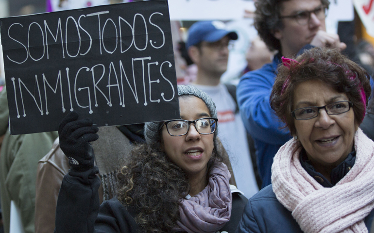 A young woman carries a sign that reads "We are all immigrants" during the Women's March on New York City Jan. 21. (CNS/Octavio Duran)