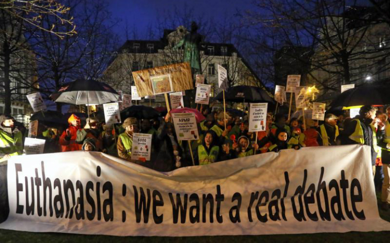 Activists of the collective Yellow Safety Jacket take part in an anti-euthanasia protest Feb. 11, 2014, in Brussels. (CNS photo/Julien Warnand, EPA)