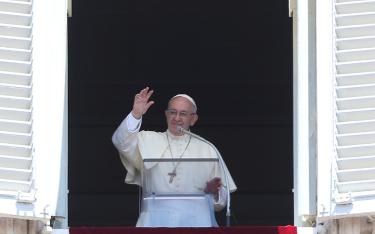 Pope Francis waves as he leads the Angelus from the window of his studio overlooking St. Peter's Square July 30 at the Vatican. (CNS/Tony Gentile, Reuters)