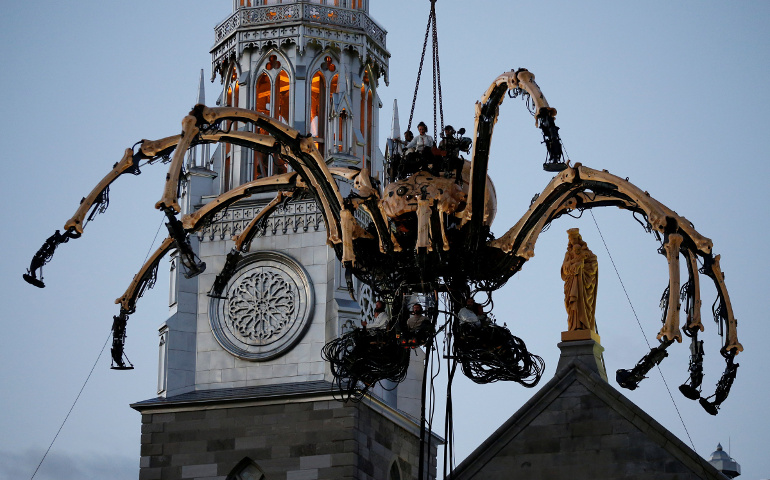 A giant mechanical spider is seen during an art performance in front of Notre-Dame Cathedral Basilica in Ottawa July 27. (CNS/Chris Wattie, Reuters) 