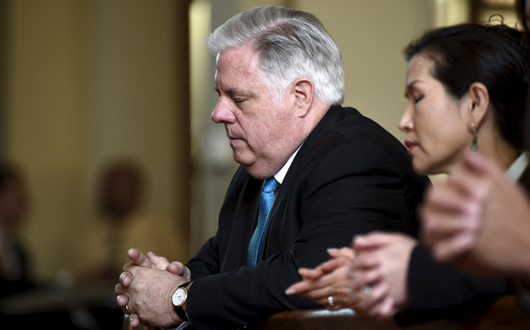 Maryland Gov. Larry Hogan and first lady Yumi Hogan pray during Mass May 3 at St. Peter Claver Church in Baltimore. (CNS/Reuters/Sait Serkan Gurbuz)