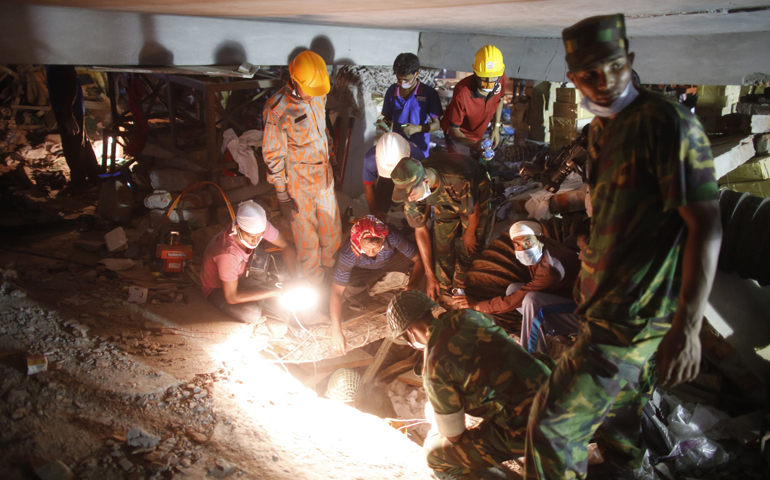 Rescue workers look for trapped garment workers April 26 at the collapsed Rana Plaza building in Savar, Bangladesh. (CNS/Reuters/Andrew Biraj)