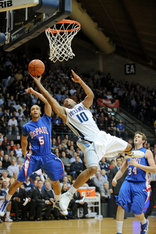 Villanova guard Corey Fisher tries to finish a shot while DePaul guard Nate Rogers looks on during a game in Villanova, Pa., Nov. 29. (Zuma Press/SCG/Mike McAtee)