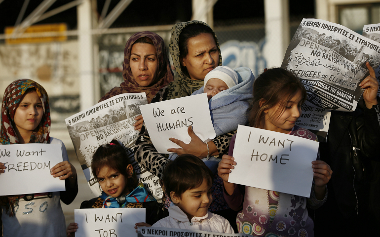 Afghan women hold placards as they take part in a protest demanding better living conditions at the refugee camp of the former international Helliniko airport in Athens, Greece, Feb. 18. Pope Francis' recent statements calling for a welcoming attitude to refugees and migrants hit a nerve on social media. (CNS photo/Yannis Kolesidis, EPA)