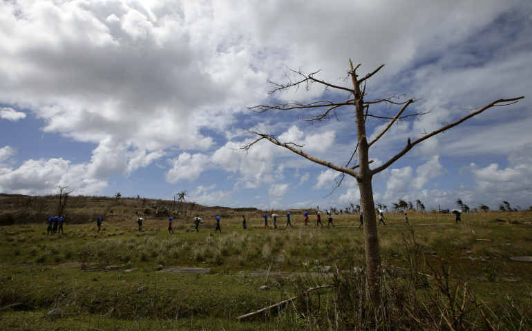 Filipinos are seen on Manicani Island in this 2013 file photo. Residents of the small island in the central Philippines celebrated a victory Aug. 18 after the government ordered a mining company to stop removing nickel ore stockpiles from their village. (CNS photo/Dennis M. Sabangan, EPA)