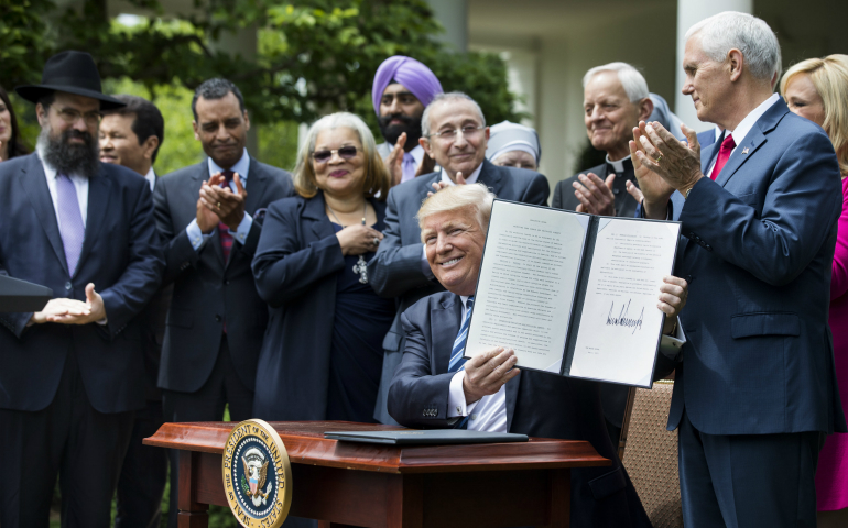 President Donald Trump shows his signed Executive Order on Promoting Free Speech and Religious Liberty during a National Day of Prayer event at the White House in Washington May 4. (CNS photo/Jim Lo Scalzo, EPA)