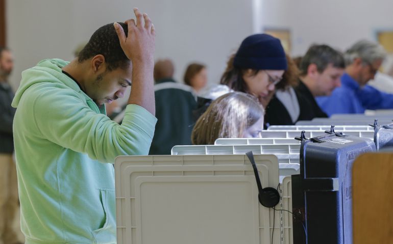 John Manson pauses while casting his ballot on Election Day, Nov. 4, 2014, at Renfroe Middle School in Decatur, Ga. Rep. Tom Price won Georgia's 6th District in that midterm election by 66.1 percent to Robert Montigel's 33.9 percent. (CNS photo/Erik S. Lesser, EPA)