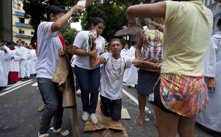  A pilgrim arrives on his knees at Our Lady of Nazareth Basilica during the 2013 Cirio de Nazare procession in Belem, Brazil. (CNS/Reuters/Paulo Santos)