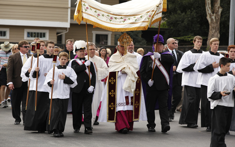 More than 2,000 Catholics process Sunday through the streets of Oklahoma City as part of a eucharistic Holy Hour led by Archbishop Paul Coakley at St. Francis of Assisi Church. The Oklahoma archbishop celebrated the Holy Hour in response to a Satanic "black mass" held the same day in a downtown arena. (CNS/Oklahoma City archdiocese/Steve Sisney)