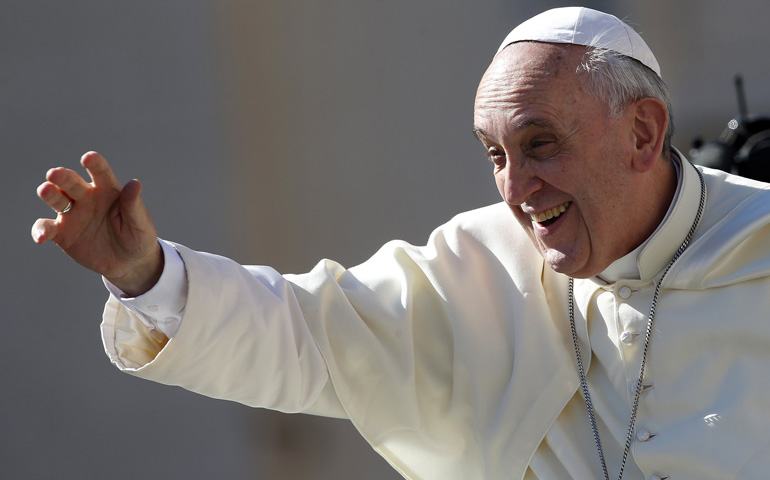 Pope Francis waves as he arrives to lead his weekly audience Wednesday in St. Peter's Square at the Vatican. (CNS/Reuters/Tony Gentile)