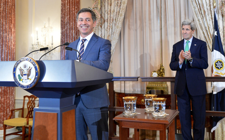 Randy Berry, left, speaks at a welcome reception in his honor while Secretary of State John Kerry watches Feb. 28 at the U.S. Department of State in Washington. (State Department)