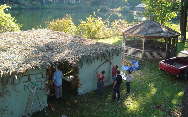 Workers build a sukkah for the Jewish harvest festival Sukkot at Adamah Farm in October 2011. (Fred Bahnson)