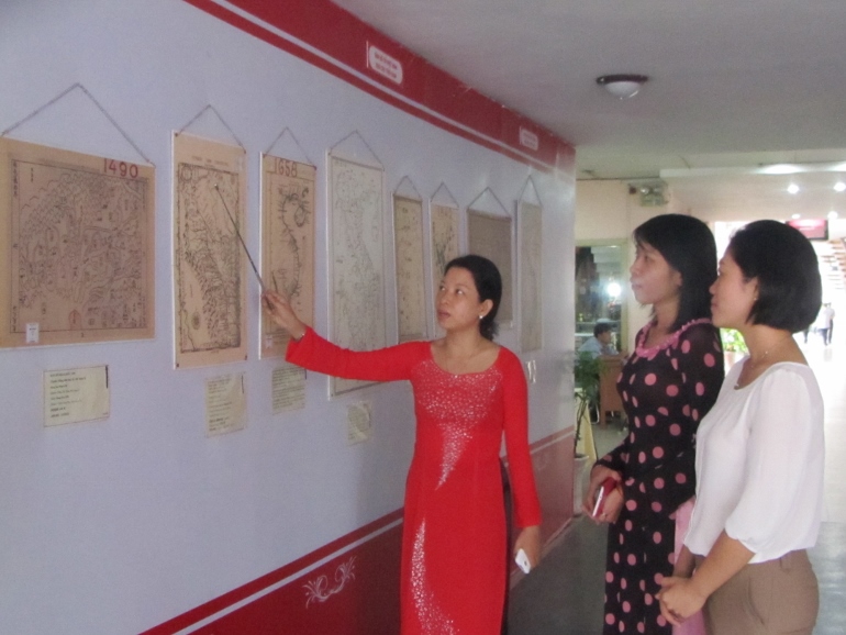 People view island maps June 19 while they were exhibited at the city’s Center for Young People. (Teresa Hoang Yen)