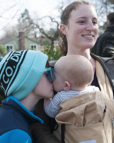 Zen Orion-Orchard, 10, kisses his younger brother, Jackson, on Feb. 4 while their mother, Melissa Orion, looks on. The Ashland, Ore., mom has declined to vaccinate her children. (CNS/Reuters/Amanda Loman)