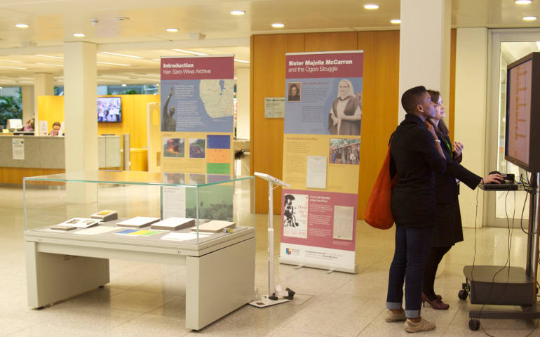 Noo Saro-Wiwa (front), daughter of Nigerian environmental activist Ken Saro-Wiwa, views the exhibition of her father's letters and poems to Our Lady of Apostles Sr. Majella McCarron and other memorabilia in the library of the National University of Ireland, Maynooth. (Alan Monahan)