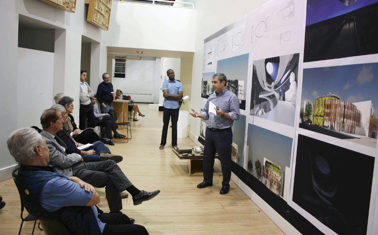 Students Sina Moayedi, standing right, and Ugochukwu Nnebue, standing center rear, present their project in a final review at Catholic University of America. (Photo courtesy of Christopher M. Crosbie)