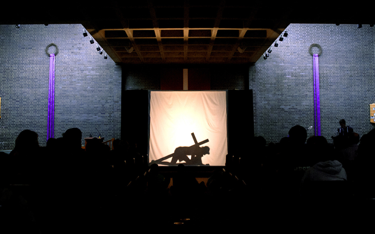 Teens perform a shadow Stations of the Cross on March 30, 2014, at Church of the Resurrection in Fairport, N.Y. (CNS/Catholic Courier/Mike Crupi)