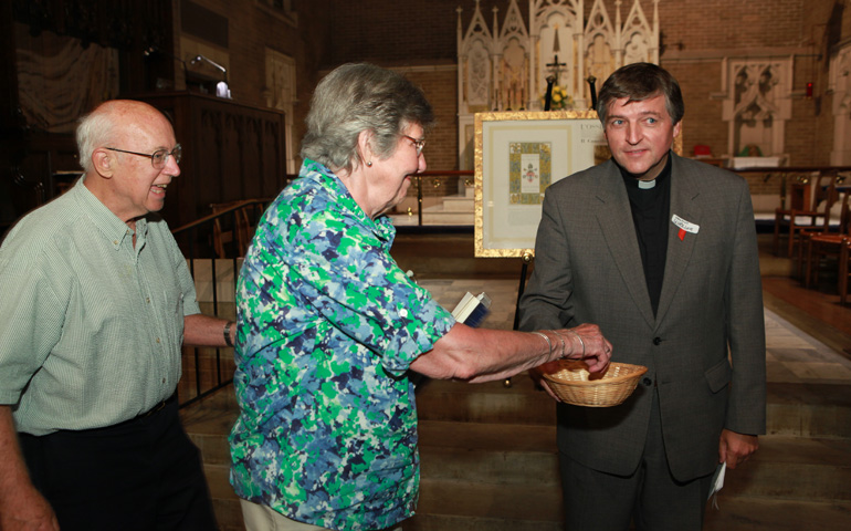 Austrian Fr. Helmut Schüller, right, shown here collecting audience members' red ribbons in Washington, D.C., ended his US tour Thursday in New York. (Rick Reinhard)