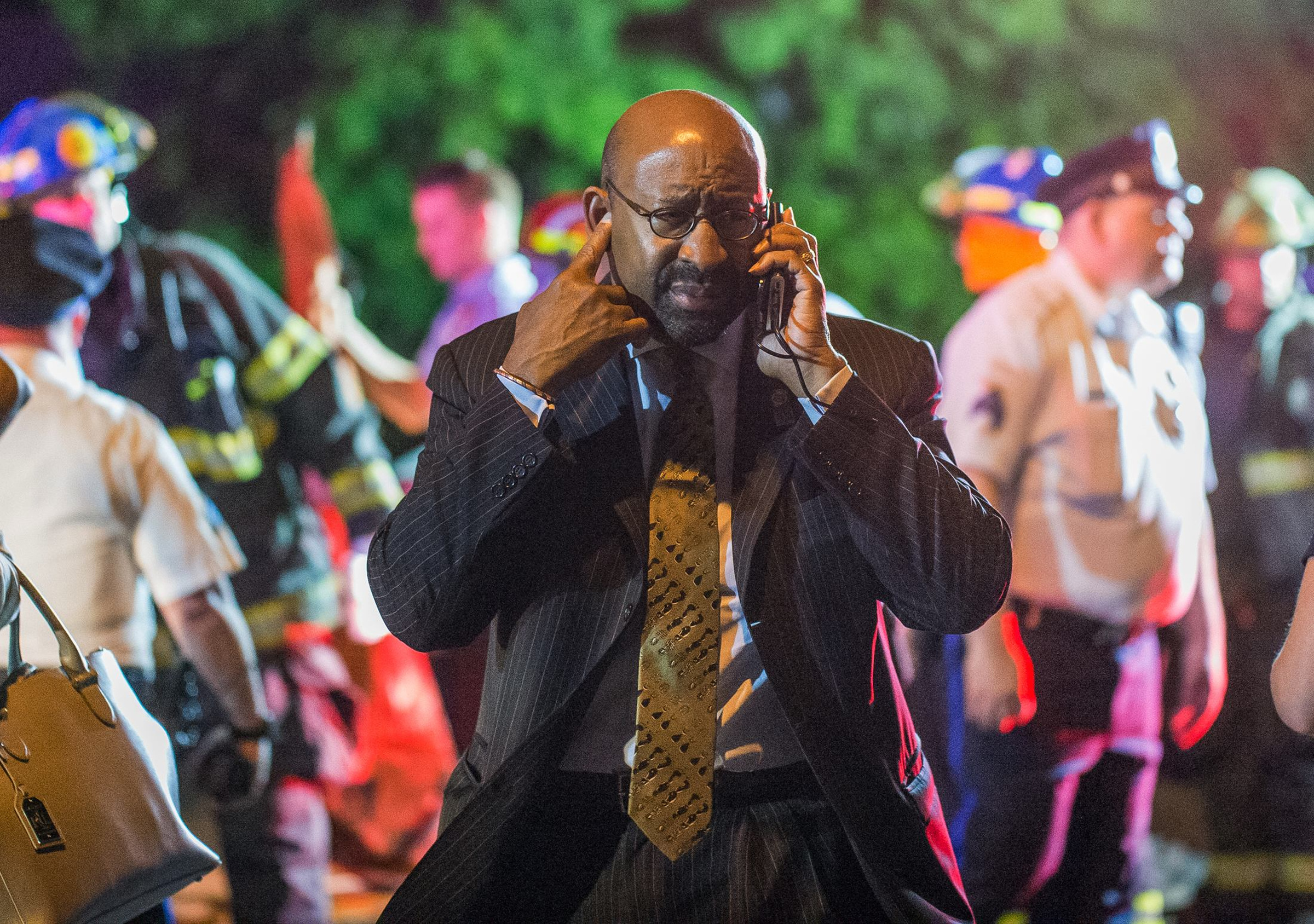 Philadelphia Mayor Michael Nutter speaks on a cellphone as emergency responders search for passengers following an Amtrak train derailment in Philadelphia Tuesday. (CNS/Reuters/Bryan Woolston)