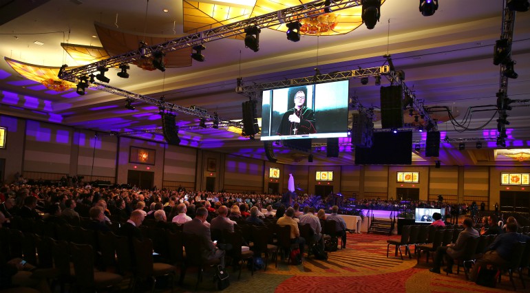 Delegates listen as Los Angeles Auxiliary Bishop Robert E. Barron is projected on a screen July 4 during the "Convocation of Catholic Leaders: The Joy of the Gospel in America" in Orlando, Fla. (CNS photo/Bob Roller)