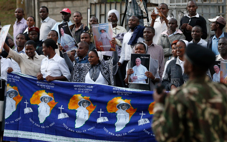 People along a street cheer Pope Francis' arrival in Nairobi, Kenya, Nov. 25. (CNS/Paul Haring)