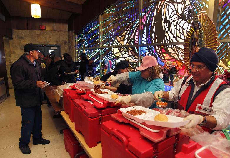 Red Cross volunteers serve hot meals to those affected by Hurricane Sandy at St. Gianna Beretta Molla Church in Northfield, N.J., Nov. 5. Catholic Charities was working jointly with the American Red Cross at the church to assist residents suffering power outages and other effects of the late October superstorm. (CNS photo/Bob Roller)