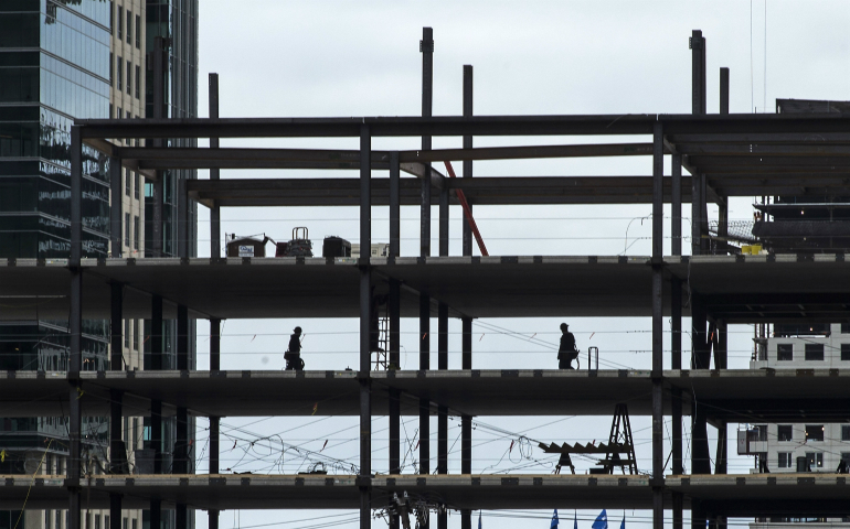 Steelworkers are seen in Boston in April 2014. (CNS photo/CJ Gunther, EPA)