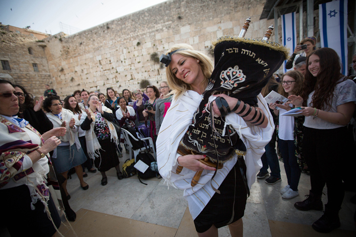 Women of the Wall, who retrieved a Torah scroll from the men’s prayer section despite regulations against women reading from a Torah at the Western Wall, celebrate during their monthly prayer service at the wall. (Miriam Alster/Flash 90)