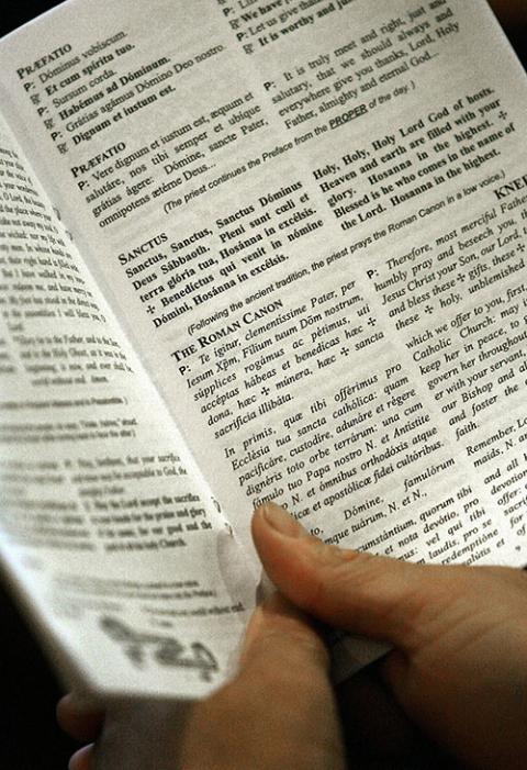 A parishioner holds a program during a Tridentine Mass at St. Therese Church in Collinsville, Oklahoma, Sept. 14, 2007, the day expanded use of the Latin Mass as authorized by Pope Benedict XVI went into effect. (CNS/Eastern Oklahoma Catholic)