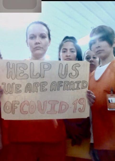 Migrants detained in an Immigration and Customs Enforcement facility in Basile, Lousiana, display signs April 3 related to the coronavirus disease. (CNS/Handout via Reuters) 