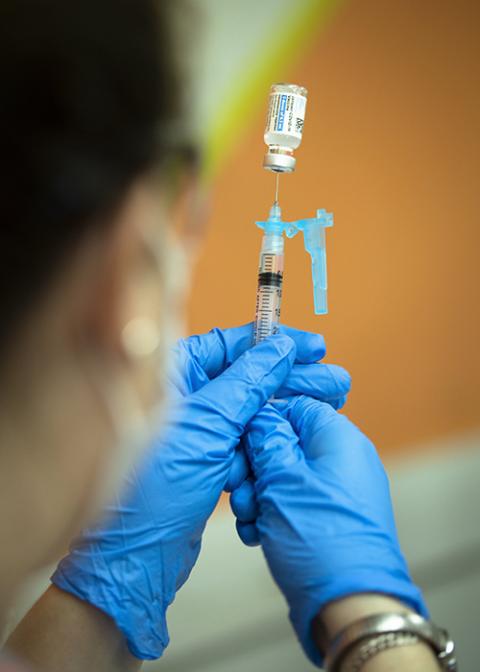 A health care worker at Catholic Charities in Washington prepares to administer the Johnson & Johnson COVID-19 vaccine May 18. (CNS/Tyler Orsburn)