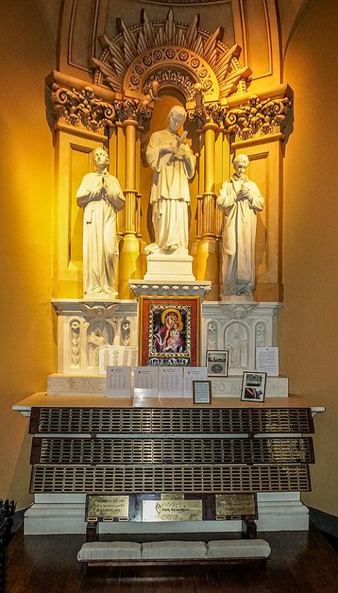 A side altar at St. Francis Xavier is dedicated to Jesuit St. Aloysius Gonzaga, in memory of all of the parishioners who died of AIDS complications. (NCR photo/Camillo Barone)