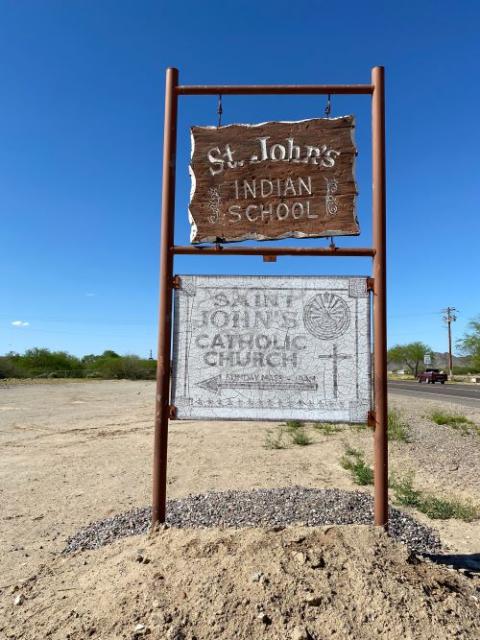 Road signs point to St. John's Catholic Church and the now closed St. John's Indian School on the Gila River Indian Community near Phoenix, Arizona.