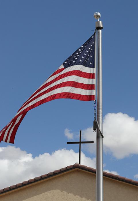 An American flag frames a cross atop Immaculate Conception Catholic Church in Cottonwood, Arizona, on Oct. 29, 2024. The parish hall of the church will be a polling station for voters in the Nov. 5 election. (OSV News/Bob Roller)