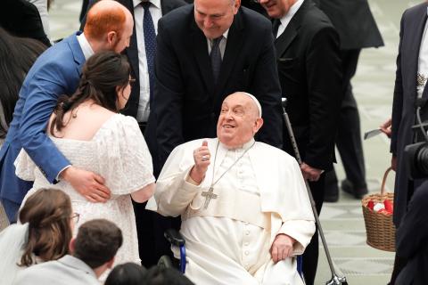  Pope Francis blesses a newlywed couple expecting a child during his weekly general audience in the Paul VI Audience Hall at the Vatican Feb. 12, 2025. (CNS photo/Lola Gomez)