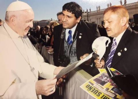 Cesar Sanabria and Juan Romero, both Villa 31 residents, talk with Pope Francis at the Vatican in 2018. Romero remembers seeing the future pope, Jorge Mario Bergoglio, in the Buenos Aires slum area in the 1990s. (Courtesy of Juan Romero) 