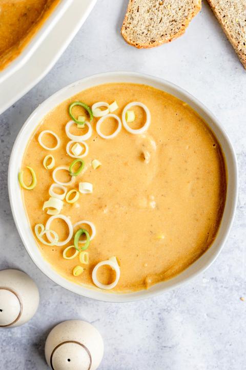 Dairy-free potato leek soup topped with chopped leeks (At Elizabeth's Table/Elizabeth Varga)