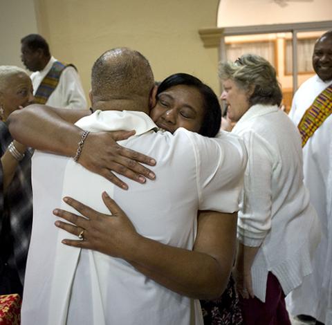 Worshippers exchange the sign of peace at St. Rita's Catholic Church in San Diego in 2019. (CNS/David Maung)