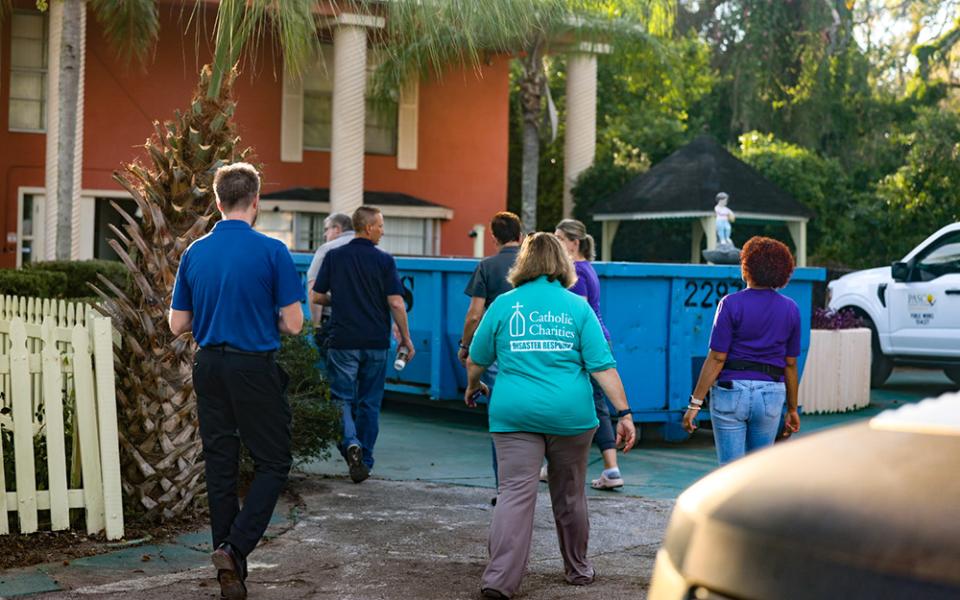 Kim Burgo, center, vice president of disaster operations at Catholic Charities USA, assesses damage in Florida with staff from Catholic Charities of the St. Petersburg Diocese in the aftermath of Hurricane Helene. (Courtesy of Catholic Charities USA/Jeremy Mines)