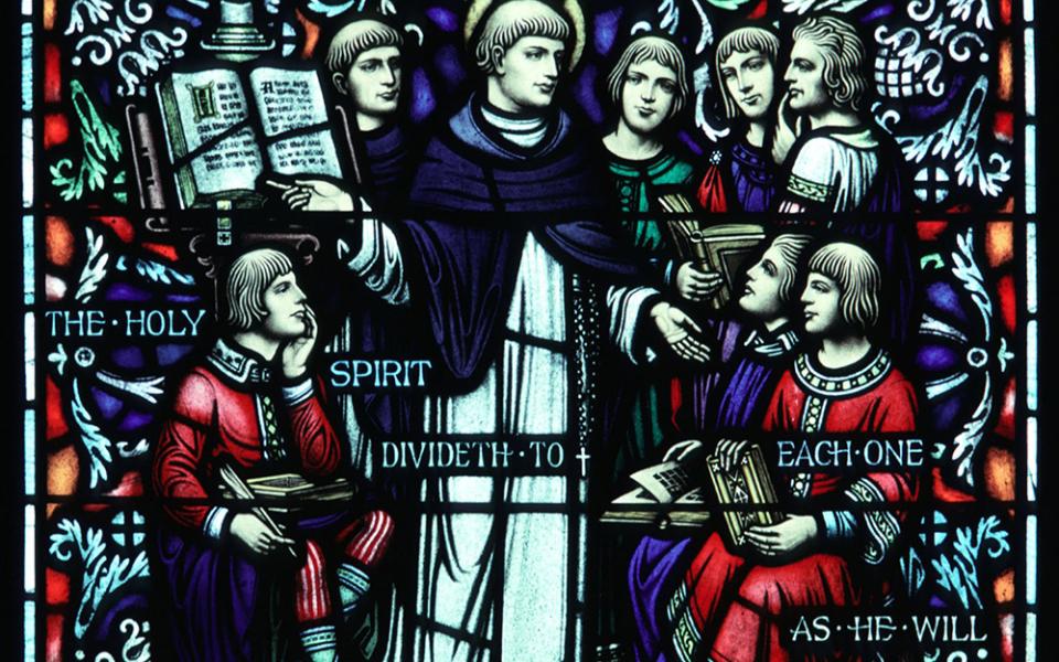 St. Thomas Aquinas is depicted with students in a window at St. Peter's Church in St. Peter, Minnesota. He wrote Summa Theologiae and articulated a theological synthesis that would influence Western Christian thought for centuries. (CNS/Crosiers)