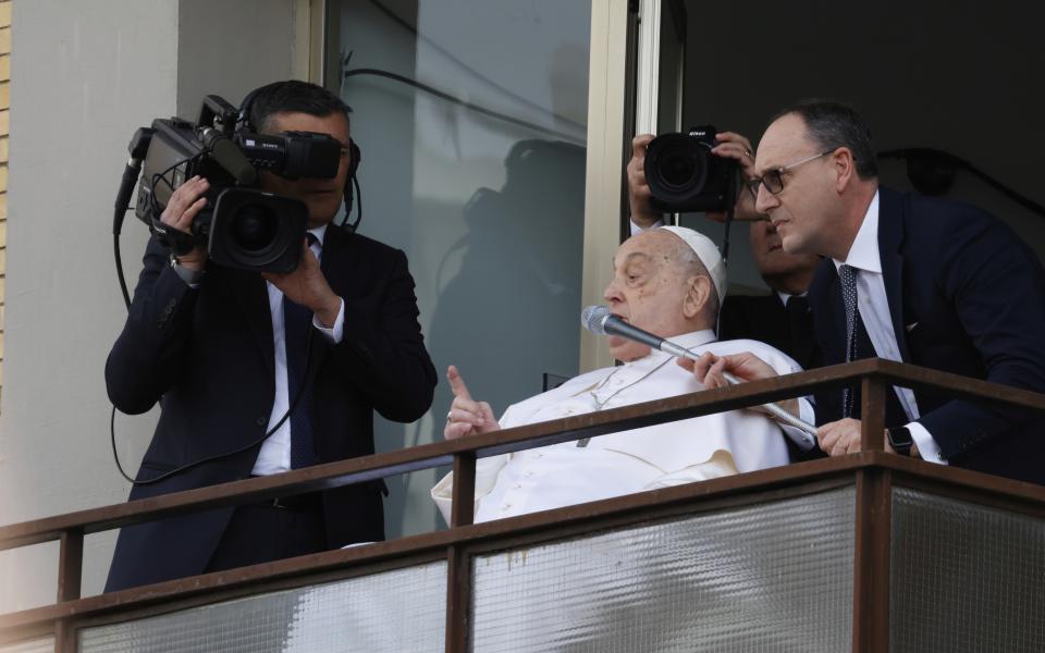 Pope Francis appears at a window of the Agostino Gemelli Polyclinic in Rome, Sunday, March 23, 2025, where he has been treated for bronchitis and bilateral pneumonia since Feb. 14. (AP Photo/Riccardo De Luca)