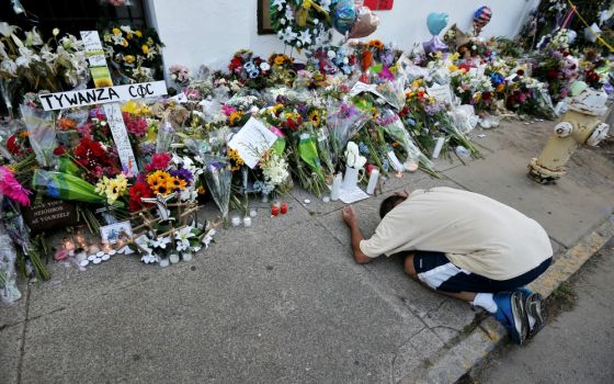 A man pays his respects outside Emanuel African Methodist Episcopal Church in Charleston, South Carolina, June 21, 2015. Nine African-Americans were shot to death by Dylann Roof at an evening Bible study inside the church June 17, 2015. (CNS/Brian Snyder)