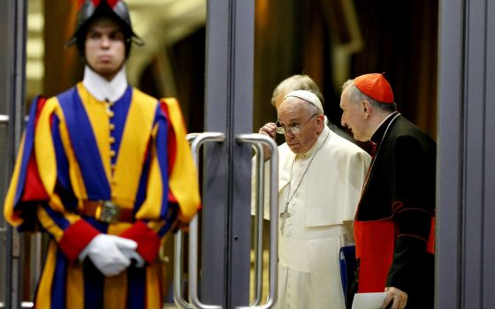 Pope Francis and Cardinal Pietro Parolin, Vatican secretary of state, talk as they leave the opening session of the Synod of Bishops on the family at the Vatican Oct. 5, 2015. (CNS/Paul Haring)