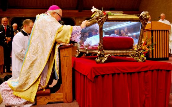 Bishop Robert Morlino of Madison, Wisconsin, venerates relics of St. Maria Goretti at St. Maria Goretti Church in Madison in 2015. (CNS/Catholic Herald/Kevin Wondrash)