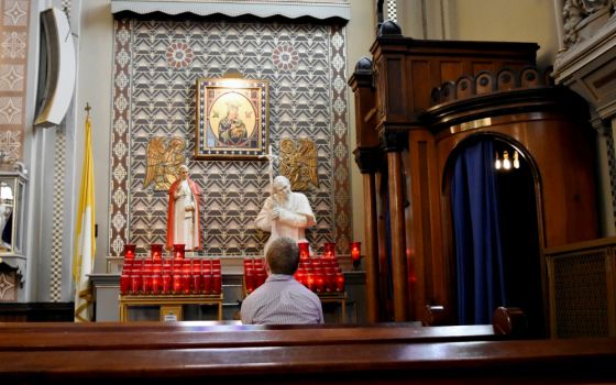 A man waits to go to confession at Old St. Mary's Church in Detroit in 2016. (CNS/The Michigan Catholic/Mike Stechschulte)