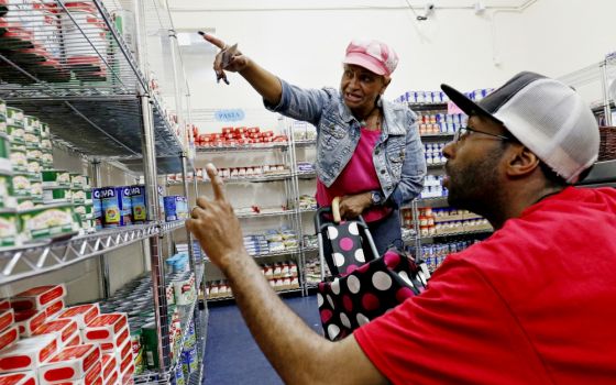 Volunteer Mark Orr assists a woman in July 2016 at a new food pantry at Catholic Charities of the Archdiocese of New York's community center in the South Bronx. (CNS/Gregory A. Shemitz)