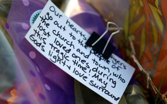 A note is seen at a memorial Nov. 7 near the site of the Nov. 5 shooting at the First Baptist Church of Sutherland Springs, Texas. (CNS/Reuters/Jonathan Bachman)