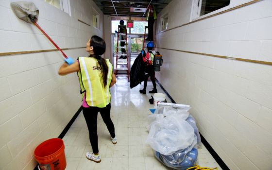 Restoration workers clean a hallway inside St. Mary School Sept. 28 in Wilmington, North Carolina, which sustained significant damage from Hurricane Florence. (CNS/Bob Roller)